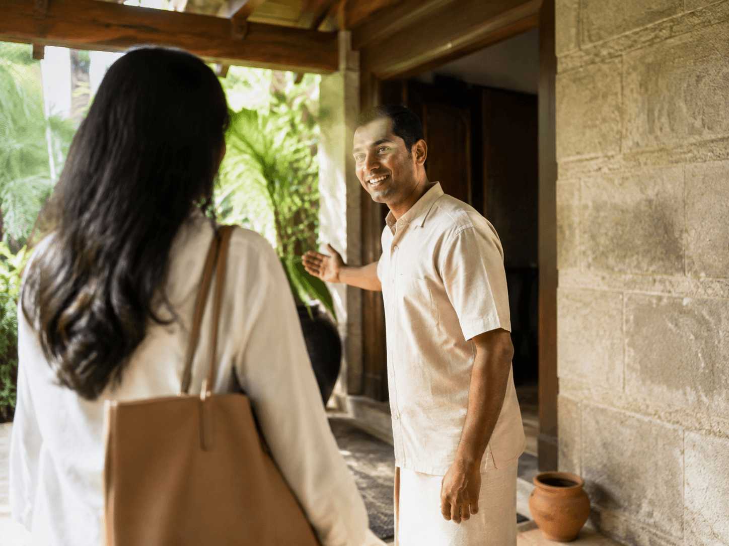 Hero image: hospitality professional welcoming a guest